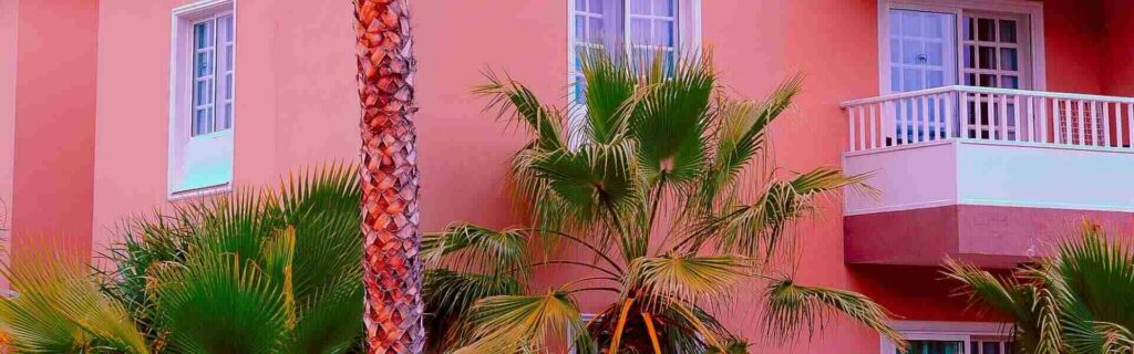 a pink three-story commercial building in st lucia