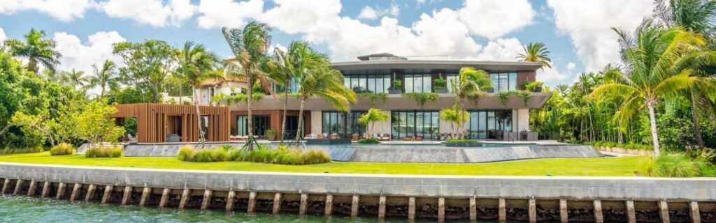 a large luxury villa in dominica with greenery on the waterfront