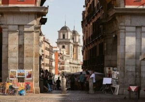 Plaza in Madrid Spain with people standing around and art displayed - digital nomads in Spain