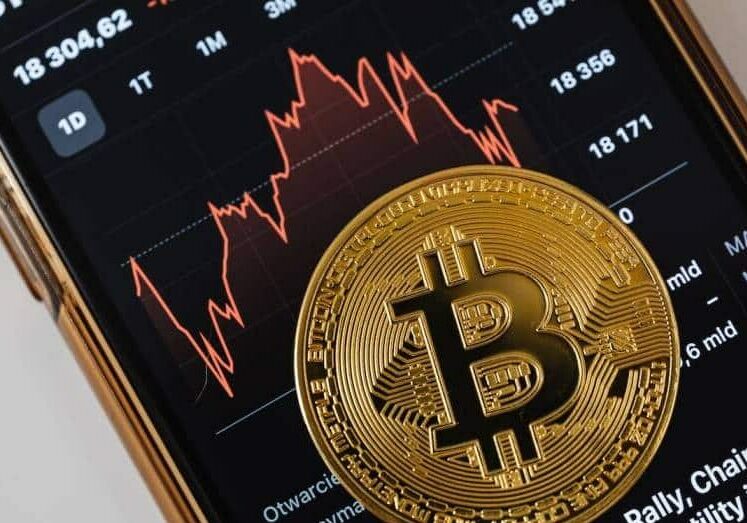 a trading app on a phone and a cryptocurrency coin