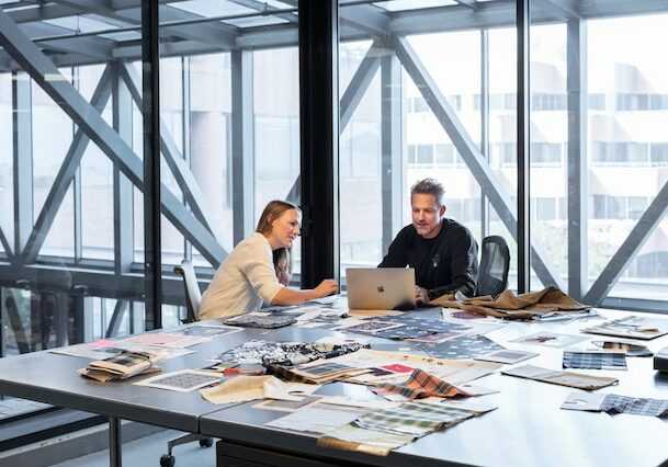 People working at a desk in a modern office - investing internationally as an expat