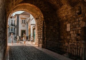 Tunnel in Portugal with people walking through it in daytime - Portugal retirement option