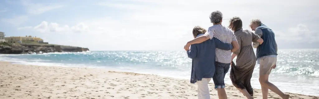 retired couples walking on a beach in Portugal