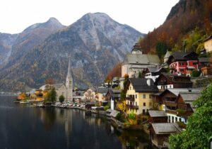 Town on a shoreline in Austria with mountains in the background - best places to retire