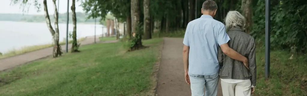 retired couple taking a walk on a park