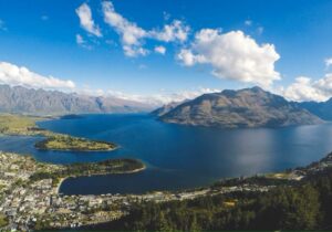 View of ocean and mountains from a hilltop in New Zealand - countries where English is an official language