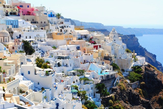 White houses in Greece, along the ocean shoreline - Citizenship by investment programs
