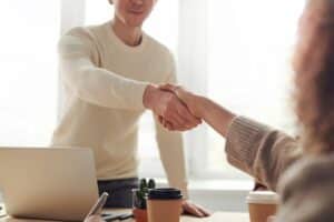 cropped shot of businesspeople shaking hands after they invest in Canada
