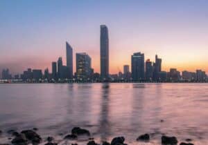 View across the water at the cityscape of the United Arab Emirates at sunset - best investment-based passports