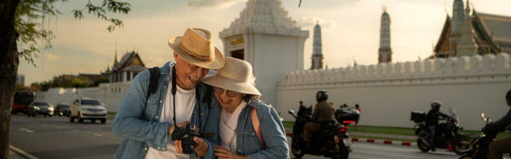 a senior couple walk the strees in thailand