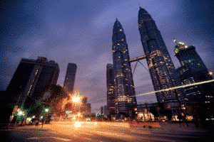 View of Malaysia's Petronas Twin Towers from below at night - best places for expats