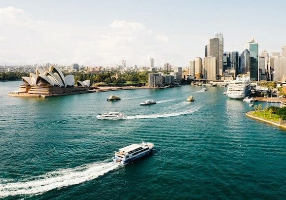 Boats going by iconic Sydney Opera House - English-speaking countries to live in