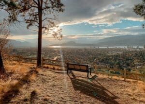 Kelowna in canada with a bench overlooking the city