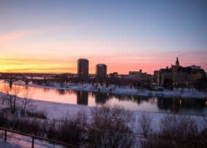 sunset in Saskatoon canada with buildings and snow