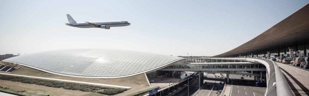 aerial view of beijing capital international airport, with a airplane flying in the background