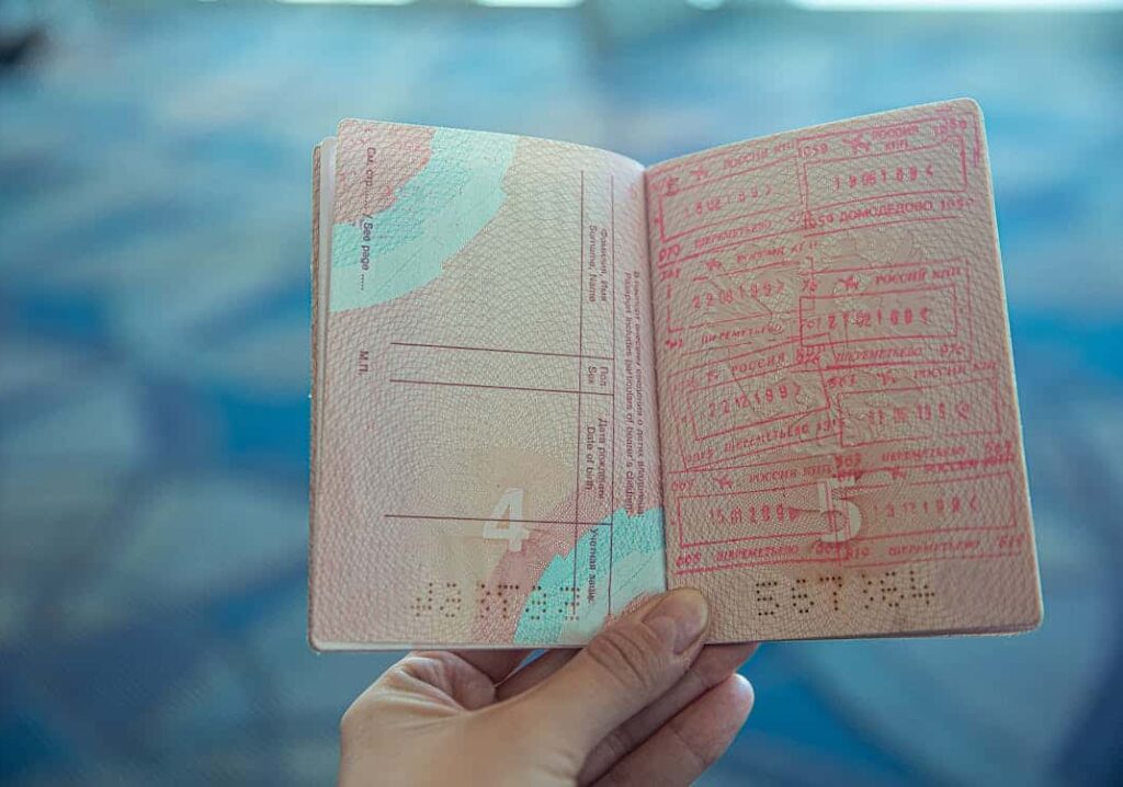 A hand holding a passport
