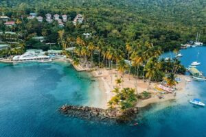 Coastline in St Kitts and Nevis with bright blue ocean and trees lining the shore - best tax-free country