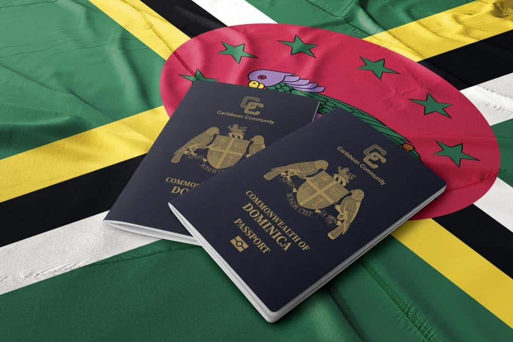 two Dominica passports on a Dominican flag