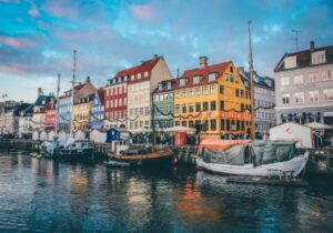 Traditional colorful Danish houses and boats moored on a river in Denmark - European countries that are best for business