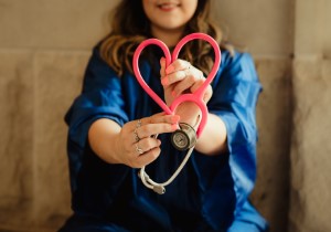 woman holding medical devices in the form of a heart in Canada