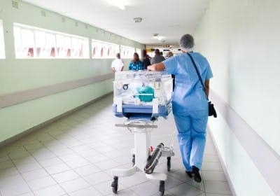 People walking through a hospital 