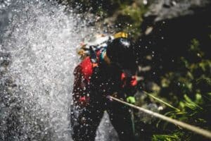 aerial view of person canyoning down a waterfall in Titou Gorge