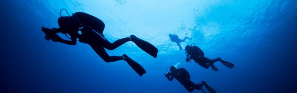 people diving off Grenada's Dragon Bay