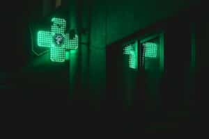 A green cross signalling a pharmacy 