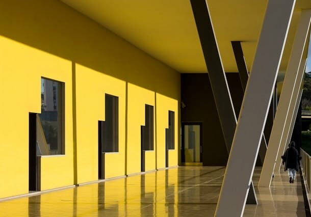 A building with interesting pillars and yellow walls