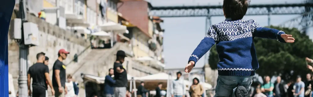 child jumping in Ribeira Porto, Portugal