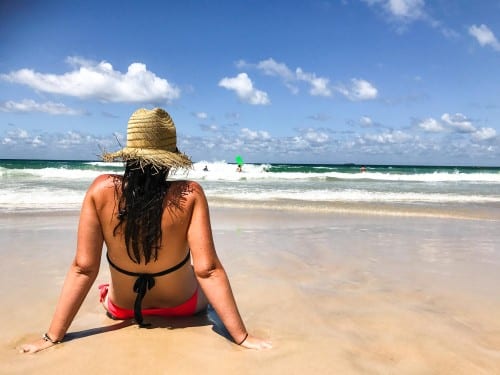 tourist sitting on a beach in grenada