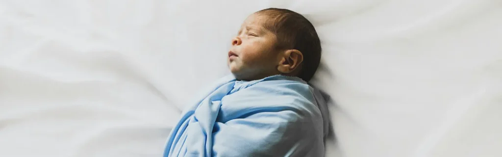 newborn baby with a blue blanket