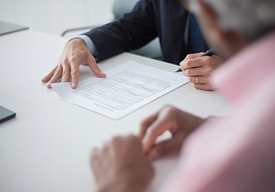 People filling and signing documents 