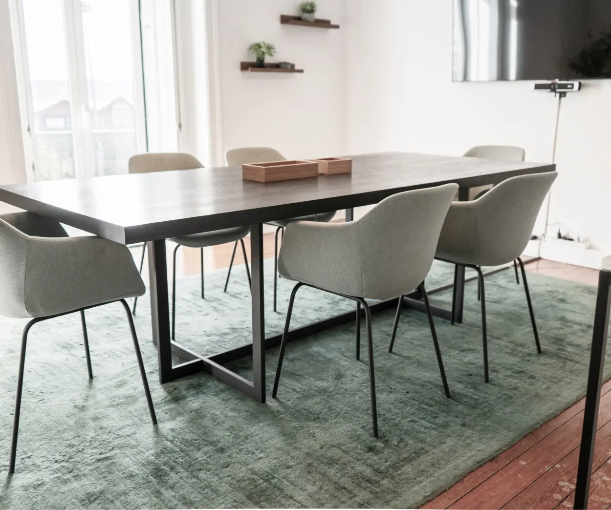 A modern dining table surrounded by four stylish chairs, set in a bright and inviting dining area.