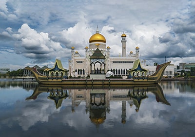 Religious building in Brunei on the water's edge with a reflection - country that does not impose personal income tax