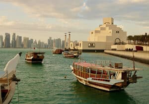 Boats moored in the ocean next to Qatar - oil-rich zero personal income tax country