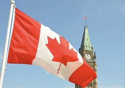 canadian flag and building in the background