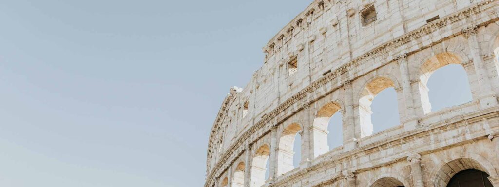 upward view of Colosseum in italy with sky in the background