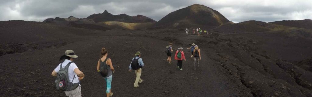 tourists hiking mount yasur