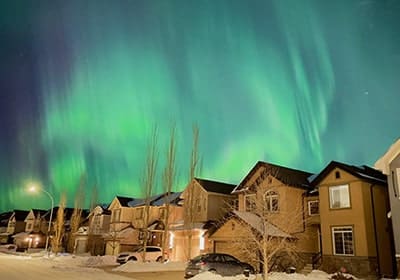 Aurora Borealis over houses in Canada - best countries to raise a family
