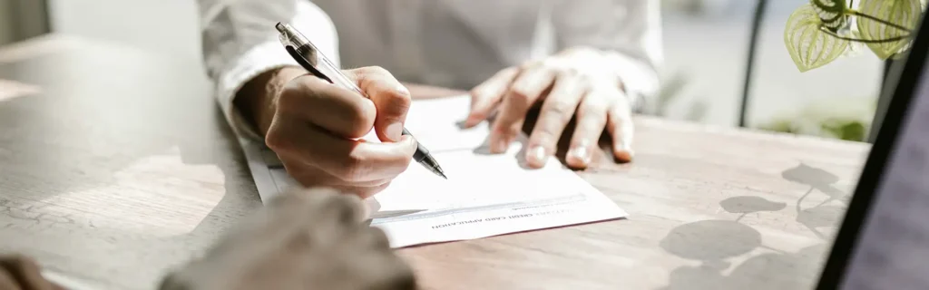 person filling out applicant to open a bank account in dominica
