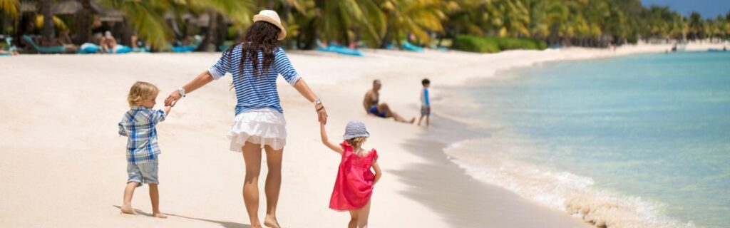 family walking along tthe beach in the caribbean