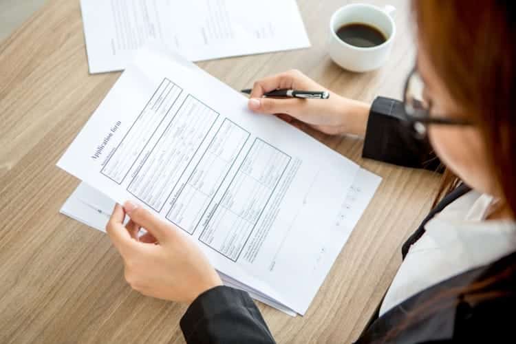 person-filling-out-application-form-for-a-nauru-passport