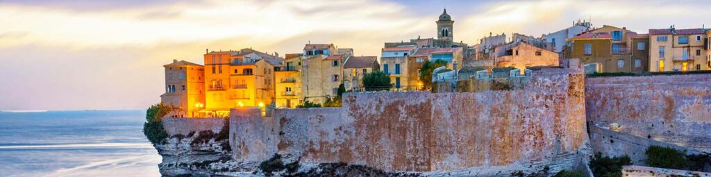 View of city, sea, sunset, and cars in Bonifacio, France - best digital nomad countries