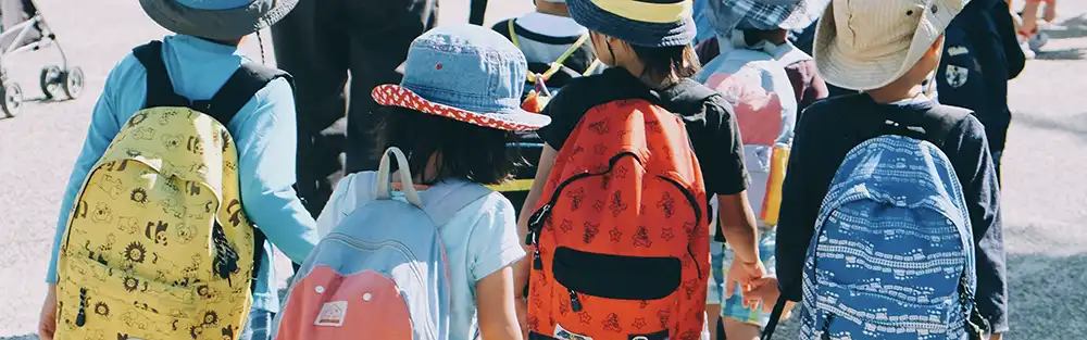 Children walking hand in hand at international school in Latvia