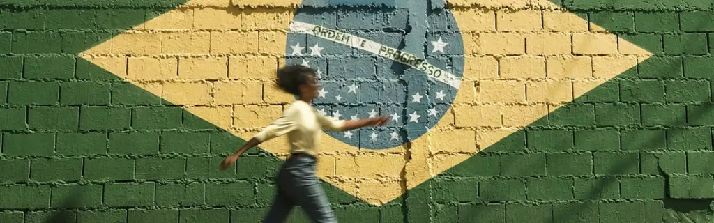 person walking with a brazil flag painted on the background